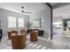 Comfortable living room featuring stylish seating, neutral tones, modern ceiling fan, and backyard views at 17710 W Guthrie St, Surprise, AZ 85388