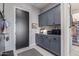 Mudroom featuring a gray storage cabinets, door, and adjacent wine storage at 17710 W Guthrie St, Surprise, AZ 85388
