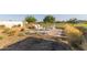 Outdoor seating area with Adirondack chairs, a brick patio, and desert landscaping creating a peaceful retreat at 17710 W Guthrie St, Surprise, AZ 85388