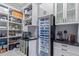 Organized pantry with white shelves, cabinets, a wine cooler, and countertop space for appliances at 17710 W Guthrie St, Surprise, AZ 85388