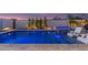 Tranquil pool with spa, integrated lighting, and poolside loungers on stone pavers at 17710 W Guthrie St, Surprise, AZ 85388