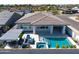 This home features a private backyard oasis with a pool, spa, covered patio, and outdoor seating area at 17710 W Guthrie St, Surprise, AZ 85388