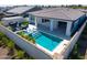 This home features a private backyard oasis with a pool, spa, covered patio, and outdoor seating area at 17710 W Guthrie St, Surprise, AZ 85388