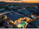 Stunning aerial view of the property with a pool and outdoor kitchen at sunset at 18126 W Ocotillo Ave, Goodyear, AZ 85338