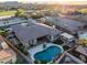 Aerial view of backyard featuring pool, outdoor kitchen, fireplace and golf course community at 18126 W Ocotillo Ave, Goodyear, AZ 85338
