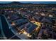 Night aerial shot showcasing a neighborhood with pools and well-lit homes at 18126 W Ocotillo Ave, Goodyear, AZ 85338