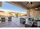 Expansive covered patio overlooking a backyard with a freeform pool, rock waterfall, and lush landscaping at 18126 W Ocotillo Ave, Goodyear, AZ 85338