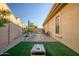 Cozy backyard with artificial turf, stone pathway, and desert landscaping at 18126 W Ocotillo Ave, Goodyear, AZ 85338
