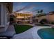 Backyard features a covered outdoor kitchen, fireplace, and sparkling pool; ideal for entertaining and relaxation at 18126 W Ocotillo Ave, Goodyear, AZ 85338