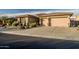 Well-maintained home with a three-car garage and mature desert landscaping at 18126 W Ocotillo Ave, Goodyear, AZ 85338