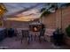 Outdoor fireplace with comfortable seating provides a cozy and inviting space for relaxing and entertaining at 18126 W Ocotillo Ave, Goodyear, AZ 85338