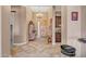 Bright foyer with decorative lighting, tile flooring, and a view of the elegant wooden front door at 18126 W Ocotillo Ave, Goodyear, AZ 85338