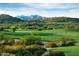 Scenic golf course view showcasing lush green fairways and mountain vistas under a clear sky at 18126 W Ocotillo Ave, Goodyear, AZ 85338