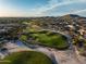 Scenic aerial view of a golf course highlighting a lush green and sand traps in a desert landscape at 18126 W Ocotillo Ave, Goodyear, AZ 85338