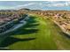 Expansive aerial view of a lush golf course with manicured greens and desert surroundings at 18126 W Ocotillo Ave, Goodyear, AZ 85338