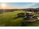 Aerial view of a golf course featuring sand traps and lush green in a desert community at 18126 W Ocotillo Ave, Goodyear, AZ 85338