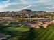 Expansive golf course view with lush green fairways, sand traps, and mountain views at 18126 W Ocotillo Ave, Goodyear, AZ 85338