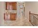 An upstairs hallway with built-in cabinets and shelving with tile floors at 18126 W Ocotillo Ave, Goodyear, AZ 85338
