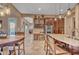 A kitchen with dark wood cabinets, granite countertops, and bar stool seating at the island at 18126 W Ocotillo Ave, Goodyear, AZ 85338