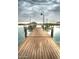 Scenic lake pier with lampposts offering tranquil views of calm water and distant landscape at 18126 W Ocotillo Ave, Goodyear, AZ 85338