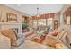 Relaxing living room with comfortable seating, a fireplace, and a large television at 18126 W Ocotillo Ave, Goodyear, AZ 85338