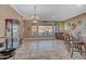Spacious living room with a full bar, elegant chandelier, and view of the pool at 18126 W Ocotillo Ave, Goodyear, AZ 85338