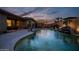 Stunning pool area with outdoor kitchen, landscaping, and covered seating at 18126 W Ocotillo Ave, Goodyear, AZ 85338