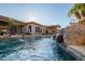 Relaxing pool area with a waterfall feature and lounge chairs at 18126 W Ocotillo Ave, Goodyear, AZ 85338