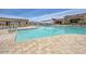 Community pool area with lounge chairs and mountain views, perfect for relaxation at 18126 W Ocotillo Ave, Goodyear, AZ 85338