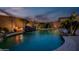 Stunning backyard with a freeform pool featuring a rock waterfall, mature landscaping and privacy wall at 18126 W Ocotillo Ave, Goodyear, AZ 85338