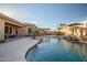 Inviting backyard pool with stone surround, waterfall feature, and lush landscaping at 18126 W Ocotillo Ave, Goodyear, AZ 85338