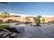Backyard featuring a freeform pool with rock waterfall, lush landscaping, and a spacious patio perfect for outdoor enjoyment at 18126 W Ocotillo Ave, Goodyear, AZ 85338