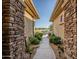 The property features a stone walkway leading to lush green space at 18126 W Ocotillo Ave, Goodyear, AZ 85338