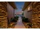Exterior walkway showcasing stone walls and manicured landscaping leading to a serene outdoor view at 18126 W Ocotillo Ave, Goodyear, AZ 85338