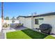 Backyard area features a small turf area with seating, barbecue, and lounge chairs for outdoor enjoyment at 2044 N 71St St, Scottsdale, AZ 85257