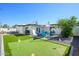 Large backyard area with a putting green and various seating areas at 2044 N 71St St, Scottsdale, AZ 85257