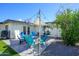 Cozy backyard patio features stylish seating around a modern fire pit with a shade cover for relaxing outdoors at 2044 N 71St St, Scottsdale, AZ 85257