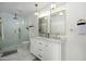 Modern bathroom features a double vanity, gold fixtures, and a glass-enclosed shower at 2044 N 71St St, Scottsdale, AZ 85257