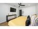 Bright bedroom featuring a ceiling fan, mounted TV, and sleek console table at 2044 N 71St St, Scottsdale, AZ 85257