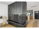 View of modern black brick fireplace next to kitchen with stainless steel appliances at 2044 N 71St St, Scottsdale, AZ 85257