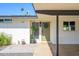 Charming front entrance showcasing a green door, stylish plants, and a welcoming aesthetic at 2044 N 71St St, Scottsdale, AZ 85257