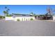 Charming single-story home with a modern aesthetic, desert landscaping and a carport at 2044 N 71St St, Scottsdale, AZ 85257