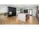 Modern kitchen boasts a large island, sleek countertops, black brick fireplace and stainless steel appliances at 2044 N 71St St, Scottsdale, AZ 85257