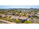 An aerial shot displays a well-planned neighborhood with homes featuring tile roofs, and mountain views in the background at 2110 E Kerry Ln, Phoenix, AZ 85024