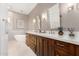 This bathroom features an elegant vanity with white countertops and fixtures plus a soaking tub at 2110 E Kerry Ln, Phoenix, AZ 85024