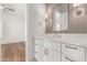 Bathroom features a white vanity with drawers, granite countertop, modern hardware, and a framed mirror at 2110 E Kerry Ln, Phoenix, AZ 85024