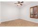 Neutral bedroom features tiled floors, modern fan, and shuttered window for natural light and privacy at 2110 E Kerry Ln, Phoenix, AZ 85024