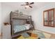 Bright bedroom featuring tiled floors, a ceiling fan, a bunkbed, and a shuttered window at 2110 E Kerry Ln, Phoenix, AZ 85024