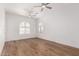 This bright bedroom features wood floors, arched windows, and three ceiling fans at 2110 E Kerry Ln, Phoenix, AZ 85024