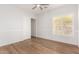 Bright bedroom with wood floors, white walls, closet, and a window providing ample natural light at 2110 E Kerry Ln, Phoenix, AZ 85024